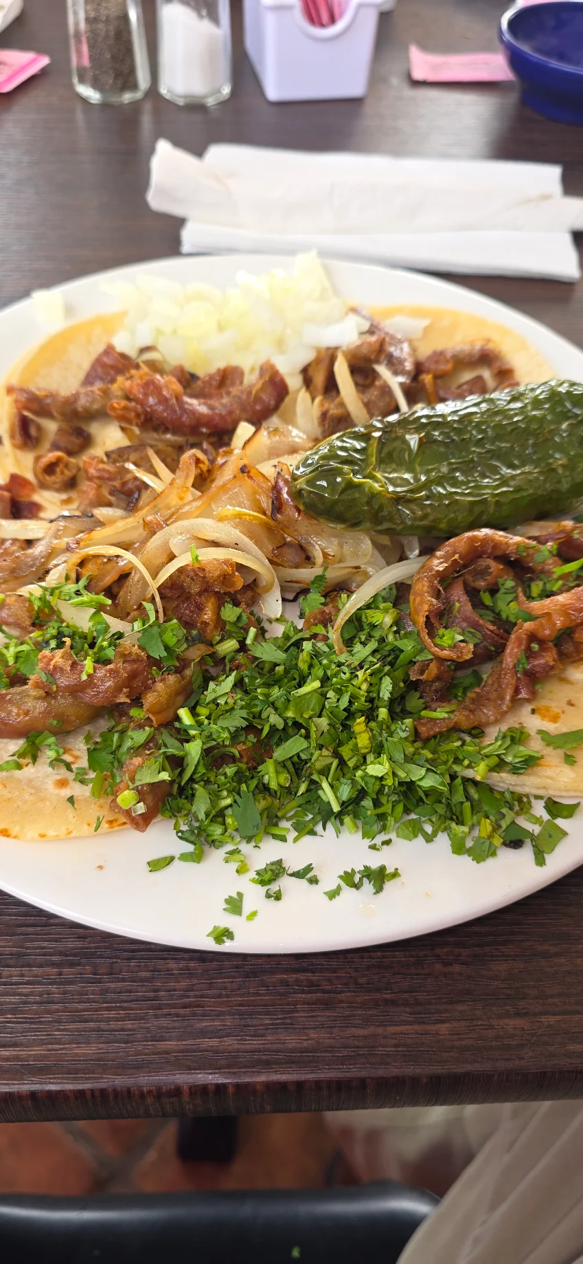 Tacos with grilled onions, cilantro, and a roasted jalapeño at Con Amor Cocina Y Cantina